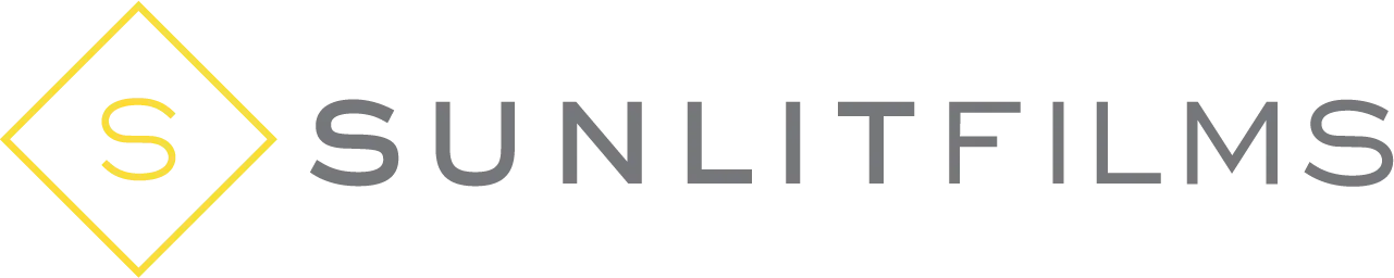 Logo of SunlitFilms with a yellow outlined diamond containing the letter "S" on the left, followed by the text "SUNLITFILMS" in gray uppercase letters.